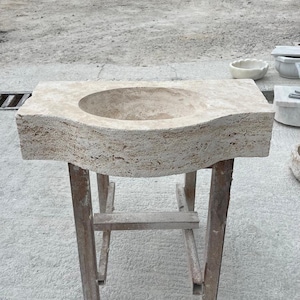Hand-carved rectangular beige travertine countertop vessel sink with a smooth honed basin, rough chiseled exterior, centered drain and single faucet hole, custom-size natural stone bathroom washbasin by MarbleSinkCo.