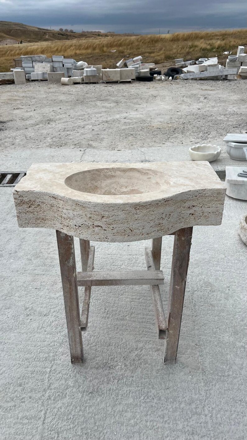 Hand-carved rectangular beige travertine countertop vessel sink with a smooth honed basin, rough chiseled exterior, centered drain and single faucet hole, custom-size natural stone bathroom washbasin by MarbleSinkCo.