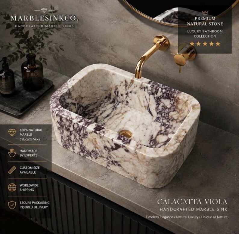 Luxury handcrafted Calacatta Viola marble floating wall mounted bathroom sink with fluted front in a premium designer bathroom.
