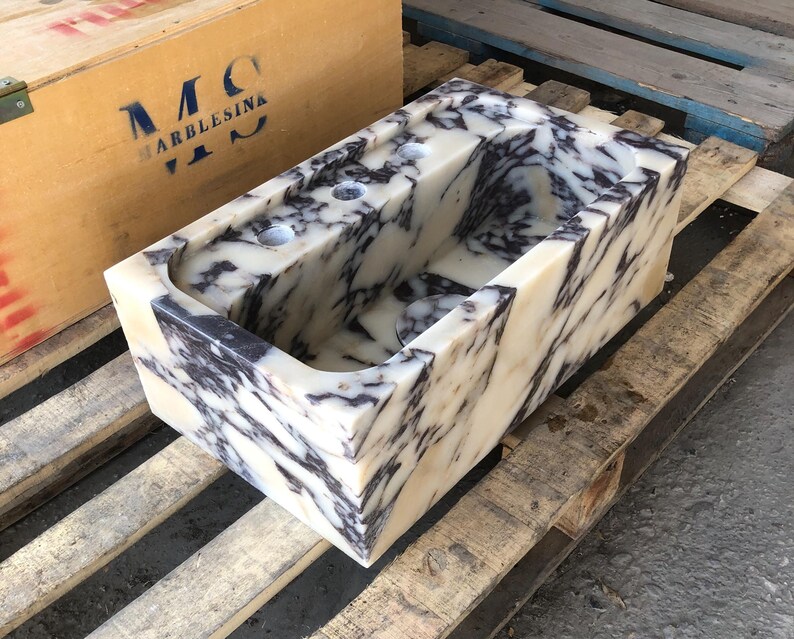 Close-up of the natural purple and burgundy veins in Calacatta Viola marble