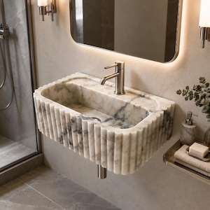 calacatta viola marble sink, fluted marble sink, grooved marble sink, wall mounted marble sink, wall hung stone basin, small powder room sink, compact bathroom sink, luxury powder room vanity, handcrafted marble basin, natural stone bathroom sink, custom marble sink, purple marble sink, burgundy marble sink, floating marble vanity, designer bathroom sink, boutique hotel bathroom sink, narrow bathroom sink, handmade stone sink, marble washbasin, architectural bathroom sink