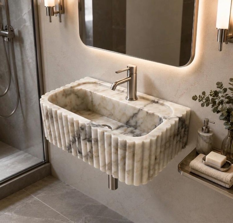 calacatta viola marble sink, fluted marble sink, grooved marble sink, wall mounted marble sink, wall hung stone basin, small powder room sink, compact bathroom sink, luxury powder room vanity, handcrafted marble basin, natural stone bathroom sink, custom marble sink, purple marble sink, burgundy marble sink, floating marble vanity, designer bathroom sink, boutique hotel bathroom sink, narrow bathroom sink, handmade stone sink, marble washbasin, architectural bathroom sink