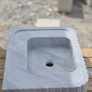 Marble bathroom sink packed in a protective wooden crate shipped with care via insured DHL Express worldwide delivery