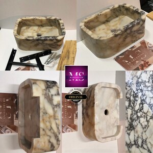 K&ouml;nnte beinhalten: Ein wei&szlig;es Marmor-Waschbecken mit einem einzigartigen Design. Das Waschbecken hat eine rechteckige Form mit einem Ausschnitt auf einer Seite. Das Waschbecken ist handgefertigt und hat eine hochwertige Verarbeitung.