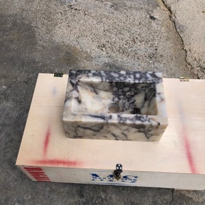 Calacatta Viola marble wall-mount sink with stunning natural veining. Handcrafted floating stone basin with no overflow, single faucet hole. Perfect for luxury bathrooms, interior designers, boutique hotels, and modern renovations. Ideal as a vessel sink, bar sink, or designer washbasin. Unique Italian marble sink for minimalist, high-end bathrooms. Trending marble bathroom decor, handcrafted stone sink.
