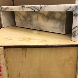 carrara-marble-sink-side-view.jpg Studio side view of the rectangular Carrara marble sink showing its height, wall edge and polished exterior profile.