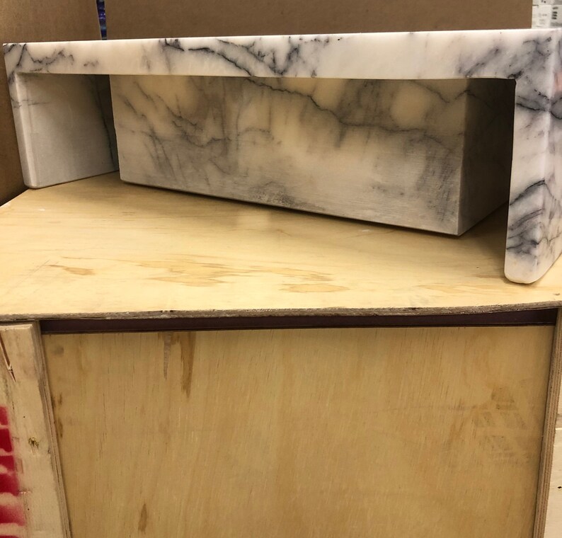 carrara-marble-sink-side-view.jpg Studio side view of the rectangular Carrara marble sink showing its height, wall edge and polished exterior profile.