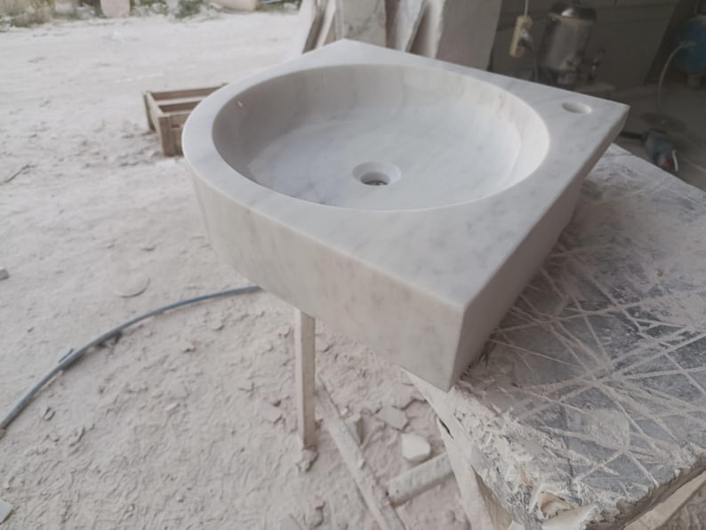 "Hand-carved Carrara marble sink – elegant, durable, and timeless. Perfect for luxury bathrooms, powder rooms, and boutique interiors. Custom sizes available: wall-mounted or countertop installation. Each piece features unique natural veining, adding character to your space. Discover our full collection of marble sinks, bathtubs, and stone accessories at MarbleSinkCo – follow us for more exclusive designs."
