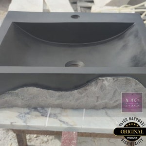 🖤 Discover the timeless beauty of our handcrafted rectangular black lava stone sink, carved from natural volcanic basalt. Perfect for wall-mounted, countertop, or vessel installations. Each piece is uniquely veined and artisan-crafted for luxury bathrooms. A bold statement for modern interior design. Durable, water-resistant, and shipped worldwide in a protective wooden crate via DHL Express.