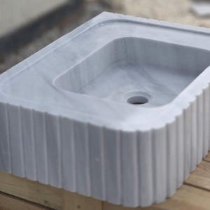 Elegant Bathroom Sink - Hand-Carved White Marble Bathroom Sink – Wall-Mounted or Countertop, Rectangular Vessel, Customizable Design - Close up of polished white marble sink bowl carved from a single block of natural stone ideal for modern and minimalist vanity designs