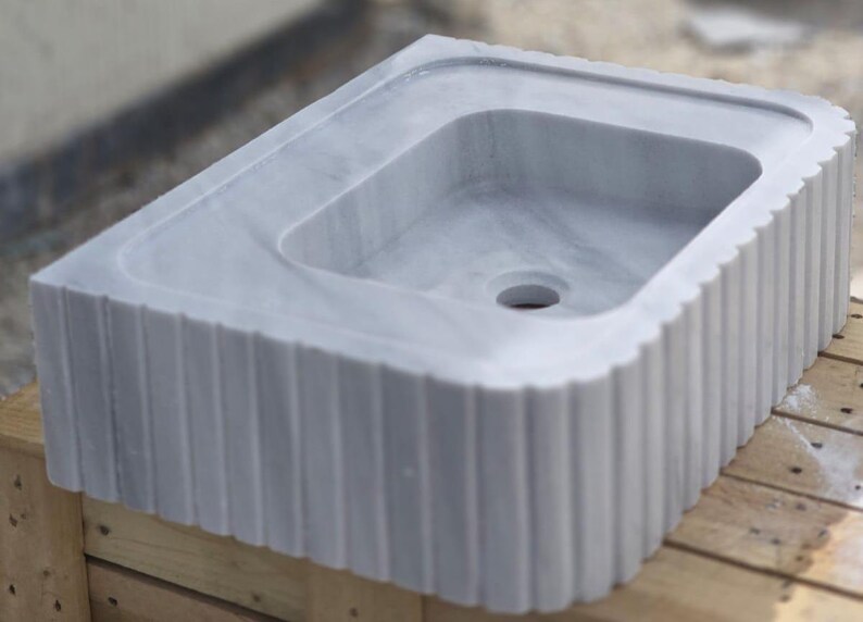 Elegant Bathroom Sink - Hand-Carved White Marble Bathroom Sink – Wall-Mounted or Countertop, Rectangular Vessel, Customizable Design - Close up of polished white marble sink bowl carved from a single block of natural stone ideal for modern and minimalist vanity designs