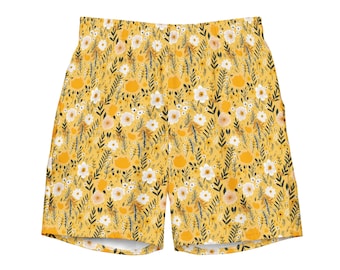 Puede incluir: Shorts amarillos con estampado floral con un patrón repetido de flores blancas y melocotón, hojas verdes oscuras y detalles amarillos. Los shorts tienen cintura elástica y están hechos de tela ligera. Perfectos para el clima cálido.