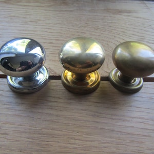 May include: Three round cabinet knobs, one silver, one gold, and one brass.