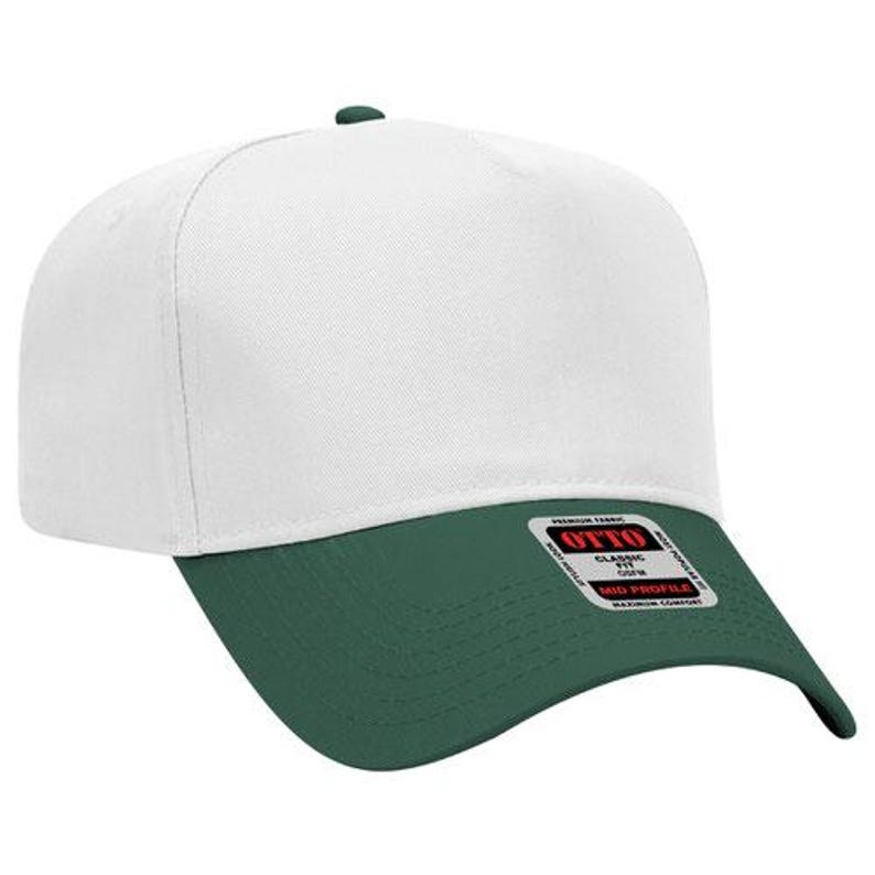 May include: A white and green baseball cap with a flat brim. The cap has a white crown and a green brim. The cap has a small green button on top. The cap has a tag that says "OTTO" on the brim.