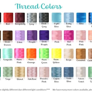 May include: A color chart displaying a wide array of thread colors, including white, black, red, and various shades of blue, green, and pink. The text "Thread Colors" is at the top. The chart includes color names like "Burgundy," "Emerald," and "Neon Pink."