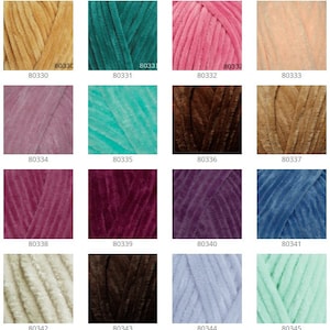 May include: A collection of 18 yarn skeins in various colors, including blue, green, pink, brown, and purple. Each skein is labeled with a number.