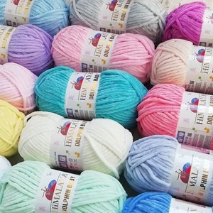 May include: Assortment of colorful yarn skeins in various pastel shades, including pink, blue, green, yellow, and white. The yarn is soft and fluffy, perfect for knitting or crocheting baby blankets, sweaters, and other projects. Each skein features the brand name "Himalaya" and the text "Dolphin Baby".