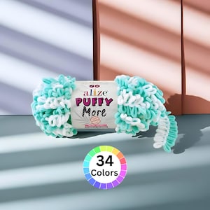 May include: A skein of Alize Puffy More yarn in shades of turquoise and white. The yarn is fluffy and textured, with a label that reads "Alize PUFFY More." A color wheel with 34 colors is also visible.
