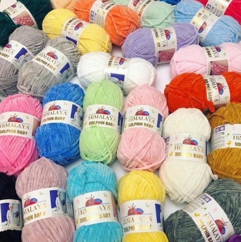 May include: A variety of colorful yarn skeins, all labeled "Himalaya Dolphin Baby". The yarn is soft and fluffy, perfect for knitting or crocheting baby items.