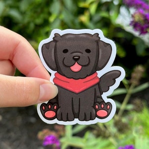 May include: A black and white cartoon sticker of a dog wearing a red bandana. The dog is sitting with its tongue sticking out.
