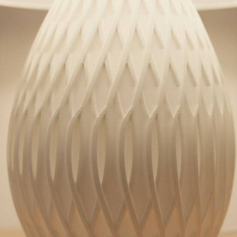 May include: A set of three ceramic mugs with a speckled, matte finish. The mugs are in shades of cream, light brown, and dark brown. Each mug has a simple, minimalist design, perfect for coffee or tea.