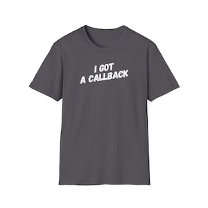May include: A dark grey t-shirt with the text "I got a callback" printed in white.