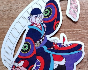 May include: A sticker of a person wearing a colorful kimono with a large, circular pattern. The person is holding a scroll in their hand and has long, pink hair. The background is a wooden surface.