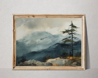 May include: A framed painting of a mountain landscape with a single pine tree in the foreground. The mountains are painted in shades of blue and gray, with a cloudy sky above. The painting is framed in a simple wooden frame.