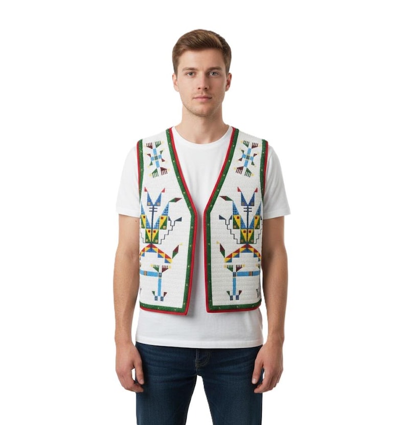 May include: A white sleeveless vest featuring a geometric pattern in blue, yellow, and green. The vest has a V-neckline, a red and green border trim, and a quilted texture. It is worn over a plain white t-shirt and dark blue denim jeans.