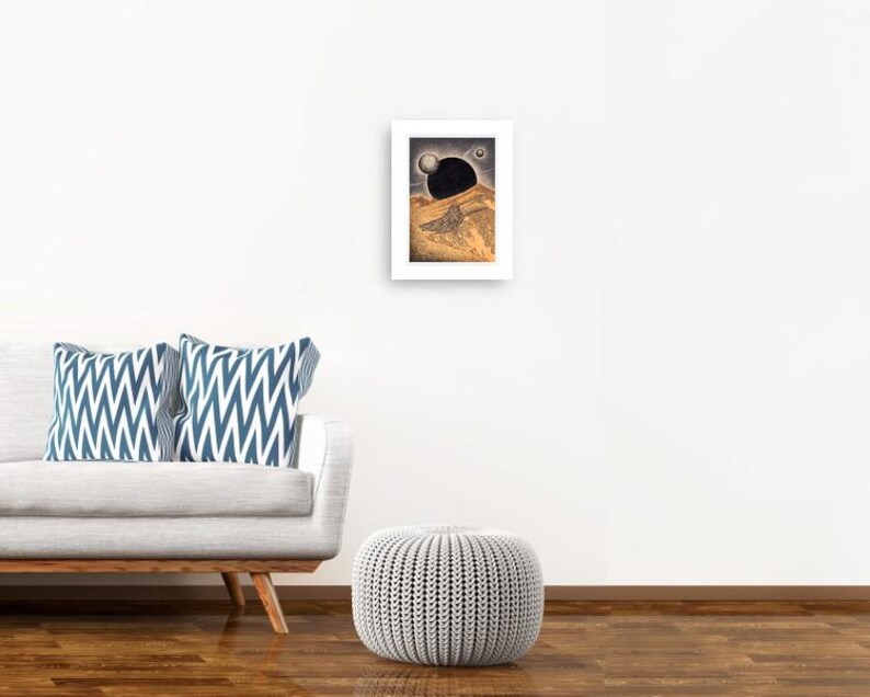 May include: A framed print of a black and white illustration of a landscape with a large black sphere in the sky.