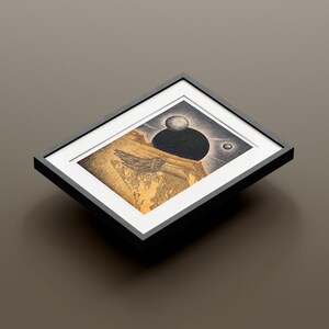 May include: A framed black and white illustration of a landscape with a large black orb and two smaller white orbs in the sky. The landscape is drawn in a detailed style with a focus on texture.