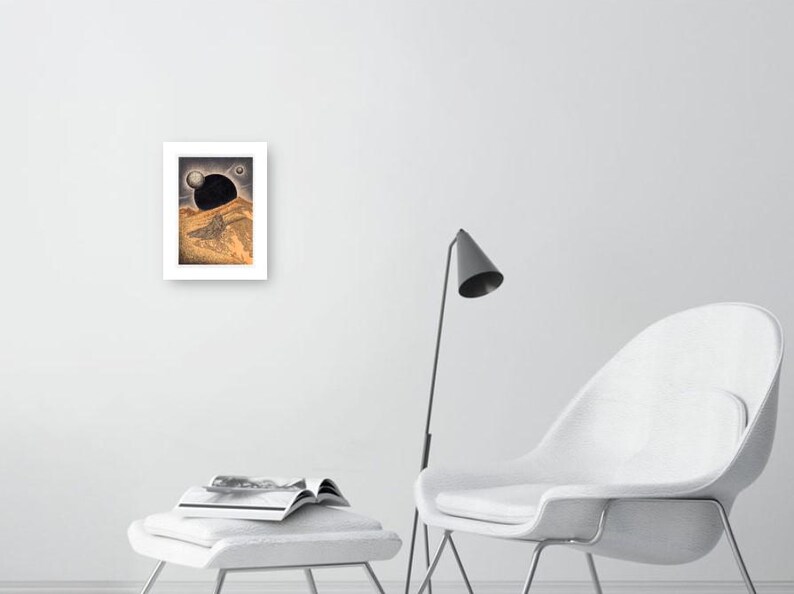 May include: A black and white drawing of a landscape with a large black orb in the sky. The orb is partially obscured by a hill in the foreground. The drawing is framed in a white frame.