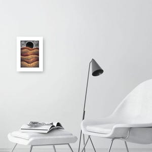 May include: A framed print of a digital illustration depicting a landscape with three wavy lines in shades of brown, orange, and red. The background is a dark gray with a black circle and two smaller white circles.