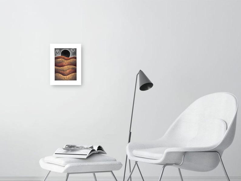 May include: A framed print of a digital illustration depicting a landscape with three wavy lines in shades of brown, orange, and red. The background is a dark gray with a black circle and two smaller white circles.