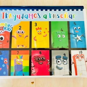 May include: A colorful learning chart with the title "TE AYUDAMOS a Enseñar" and the words "Number Blocks" in a blue and white box. The chart features ten colorful blocks, each with a number from 1 to 10 and a cartoon character.