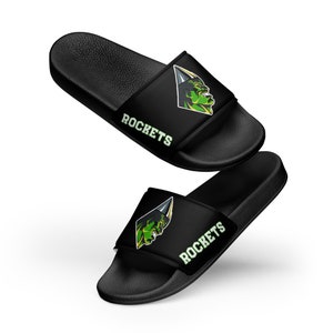May include: Black slide sandals with a green and yellow graphic of a monster's face and the word "ROCKETS" on the strap.