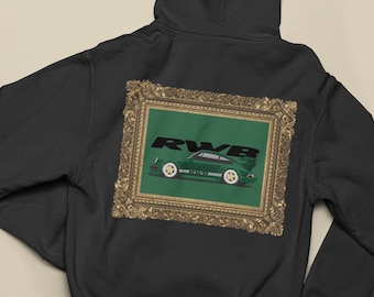 May include: Black hoodie featuring a framed graphic of a green sports car with white wheels and the text "RWB" on a green background. The frame has a gold ornate design. The hoodie has a hood and a drawstring.