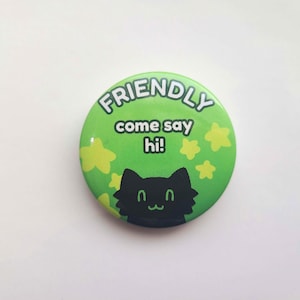 May include: Green button with the text "FRIENDLY come say hi!" and a black cat silhouette with yellow stars.