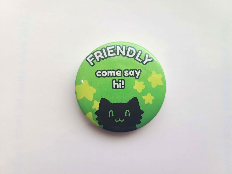 May include: Green button with the text "FRIENDLY come say hi!" and a black cat silhouette with yellow stars.