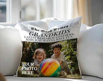 May include: A white pillow with a newspaper design featuring the text "The Good Times" and "GRANDKIDS: LATEST RESEARCH CONFIRMS: KIDS JUST WANNA HAVE FUN". A photo of two children playing with a beach ball is in the background. The text "YOUR PHOTO HERE" is at the bottom of the pillow.