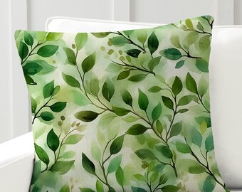 May include: A green and white throw pillow with a watercolor pattern of leaves and branches. The pillow has a soft, natural feel and is perfect for adding a touch of nature to your home decor.