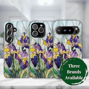 May include: Three phone cases with a stained-glass iris design in purple, yellow, and green. The cases have a light blue background and a white marble surface. A green circle with the text "Three Brands Available" is in the lower right.