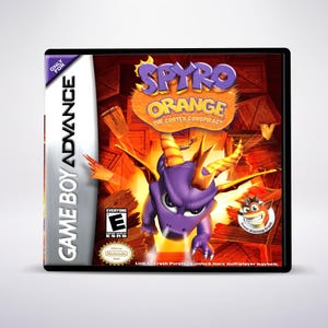 May include: A Game Boy Advance game case featuring the game "Spyro Orange: The Cortex Conspiracy." The cover art showcases a purple dragon with orange horns and wings, set against a fiery orange background. The game is rated "E" for Everyone.