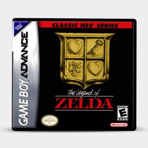 May include: Game Boy Advance game cartridge for The Legend of Zelda, a classic NES game. The cartridge is black with a gold shield design and the game title in red.