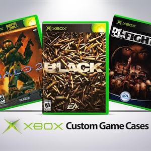 May include: Three green Xbox game cases with custom artwork. The cases feature the games Halo 2, Black, and Def Jam Fight for NY. The cases are all in the same style, with a green background and a black border.