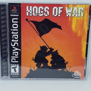 May include: PlayStation game case with a black and orange design. The title "HOGS OF WAR" is printed in white with bullet holes around the letters. The game is rated "T" for Teen by the ESRB.