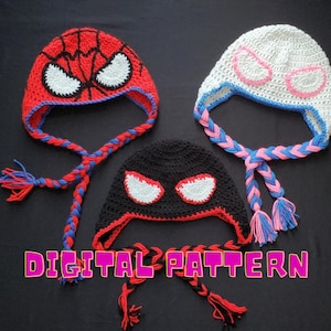 May include: Three crocheted hats with different designs. The first hat is red with a black spider-man design. The second hat is black with a white spider-man design. The third hat is white with a pink spider-man design. All three hats have long braided ties.