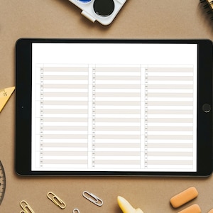 May include: A digital tablet displaying a blank printable checklist with three columns. The tablet is on a brown surface with various school supplies, including a ruler, protractor, pencils, paintbrushes, and a notebook.