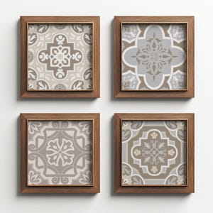 May include: Four framed square art prints with detailed, symmetrical patterns in beige, grey, and brown tones. The prints are set in wooden frames, forming a coordinated wall art set.