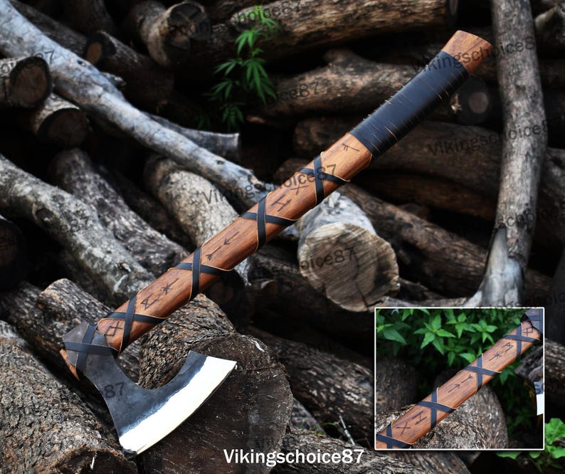 May include: A black-handled axe with a wooden shaft and a black leather wrap. The axe head is made of steel and has a sharp edge. The shaft is decorated with runes and the number "87".